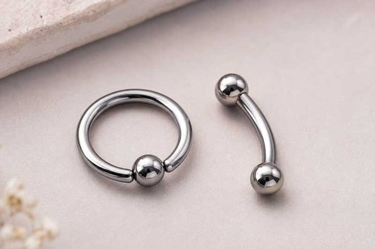 Captive Bead Rings and Curved Barbells