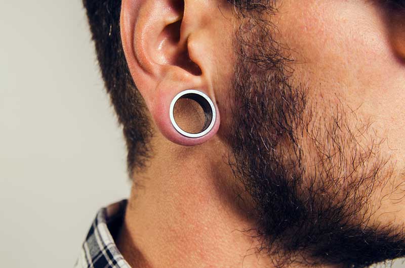 Male with ear gauge